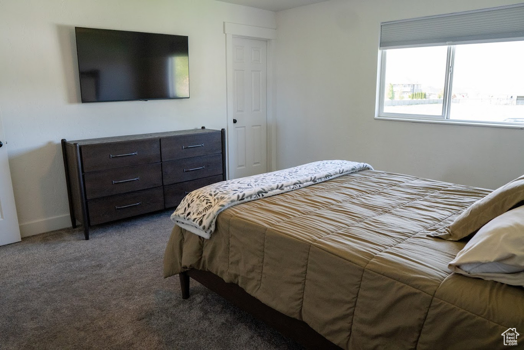 Carpeted bedroom featuring baseboards