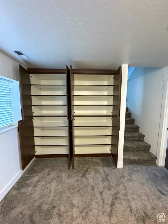 Basement with carpet floors and stairway