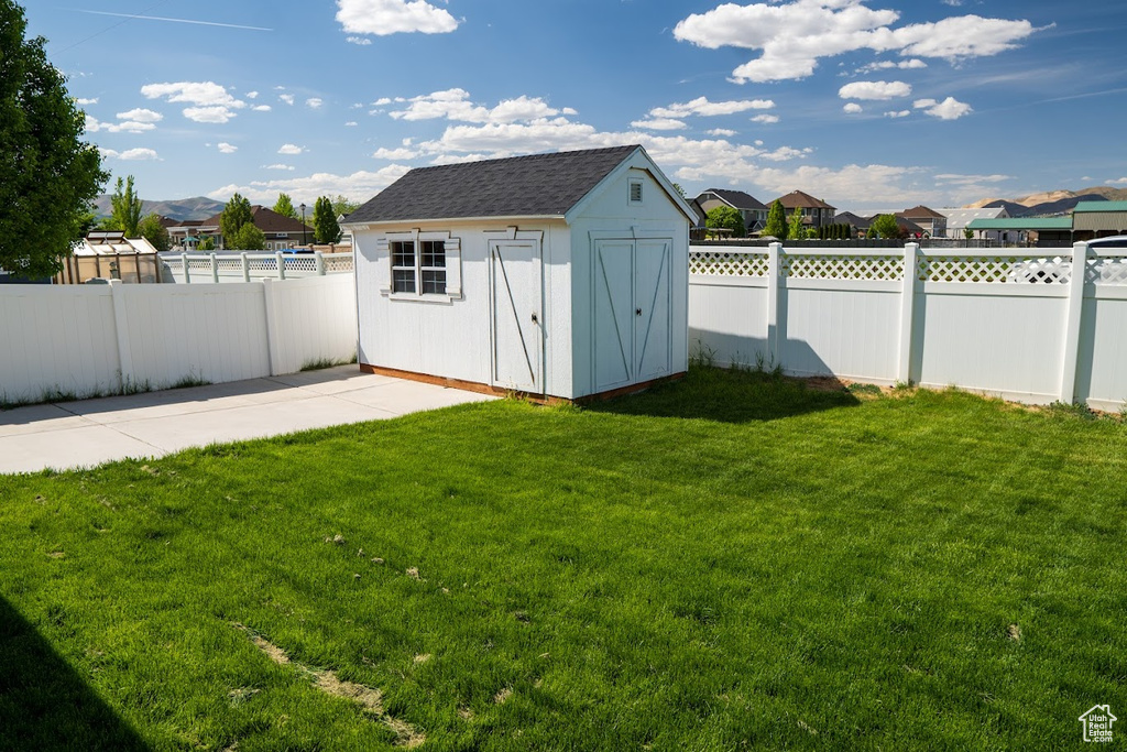 View of shed with a fenced backyard and a residential view