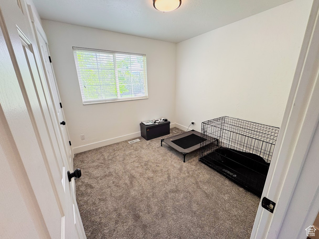 Unfurnished bedroom featuring carpet floors and baseboards