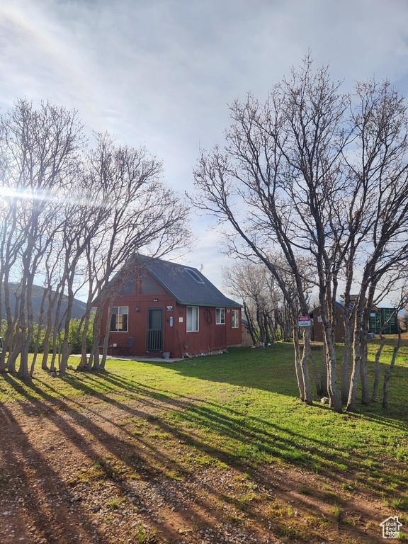 View of side of home with a lawn