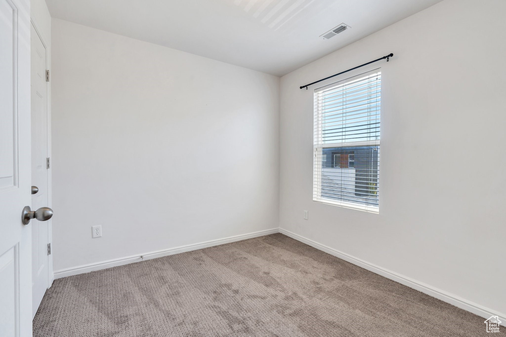 Empty room with carpet flooring and baseboards
