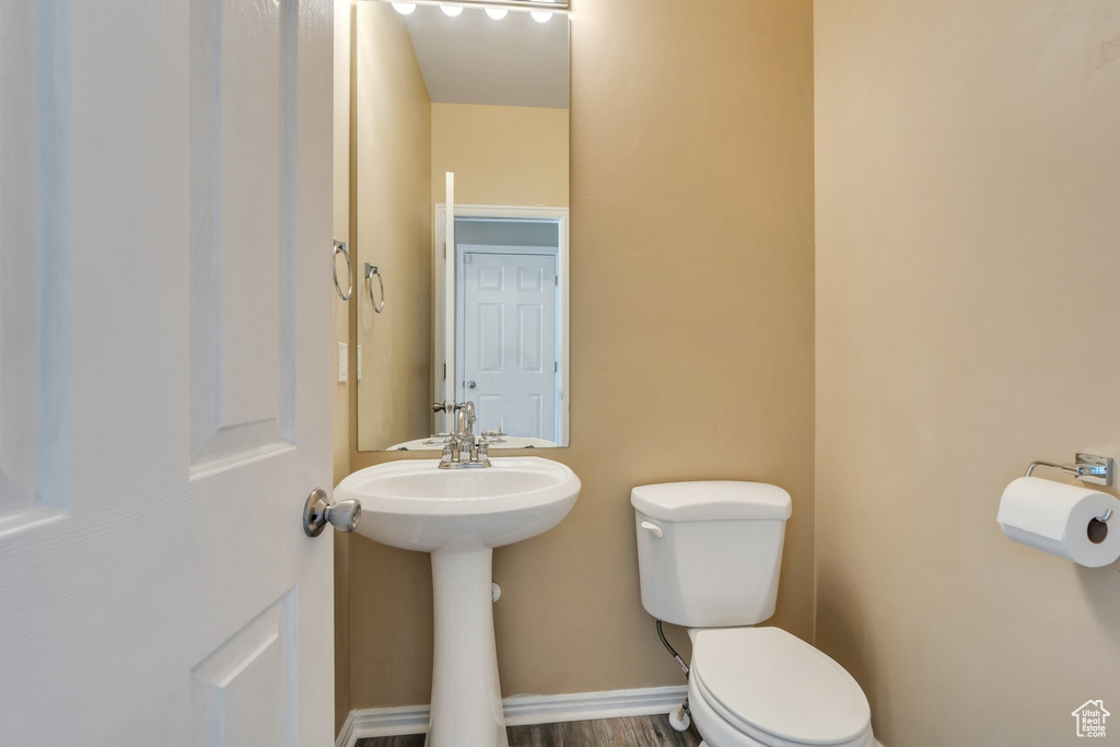 Half bath featuring toilet and a sink