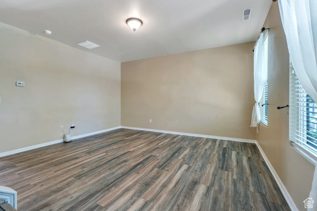 Spare room with wood finished floors and baseboards