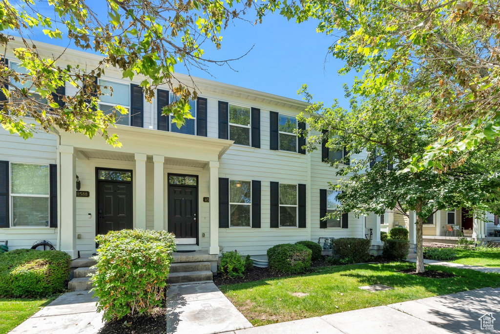 View of front of property with a front yard