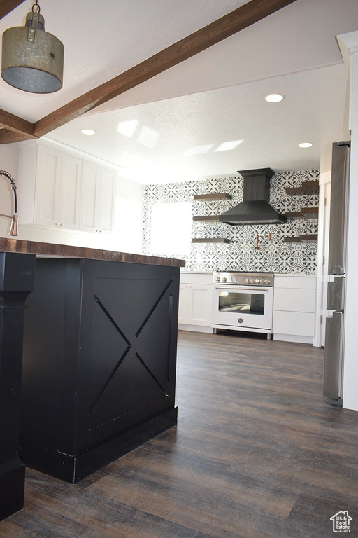 Kitchen featuring wall chimney range hood, stainless steel appliances, open shelves, white cabinetry, and beam ceiling