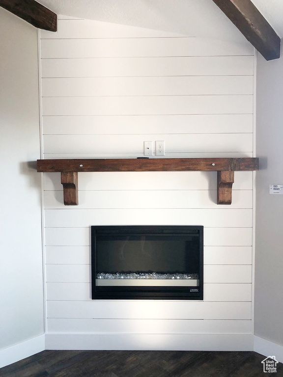 Detailed view of a large fireplace and wood finished floors