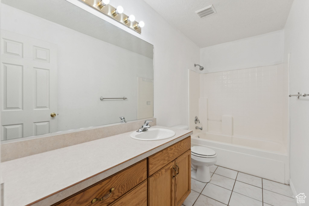 Full bath with vanity, tile patterned floors, and shower / bathtub combination