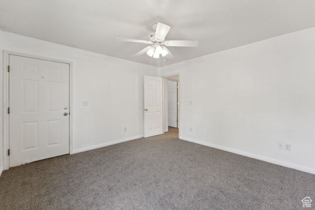 Unfurnished room featuring carpet flooring and a ceiling fan