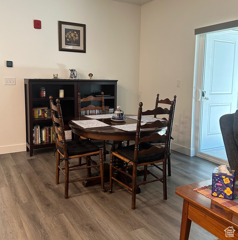 Dining room with dark wood finished floors and baseboards