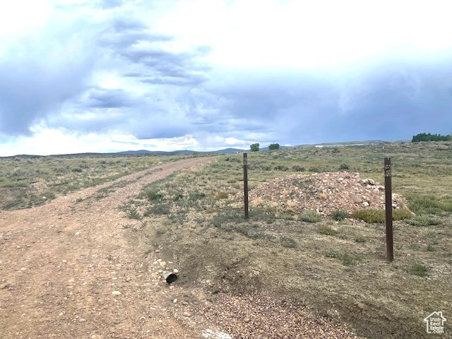 View of dirt / gravel road with a rural view