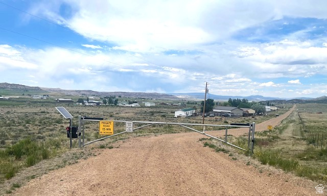 View of road featuring a view of rural / pastoral area, a gated entry, and a mountain view