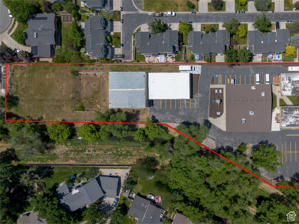 Aerial view of residential area featuring property boundaries highlighted