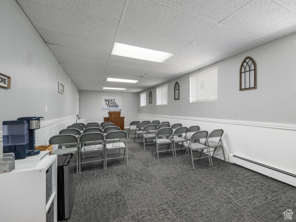 Miscellaneous room featuring a baseboard heating unit, carpet, and a drop ceiling