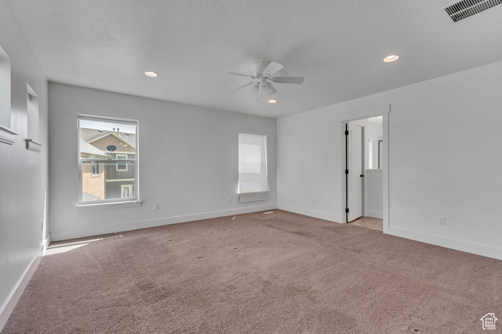 Spare room with a ceiling fan, carpet, and recessed lighting