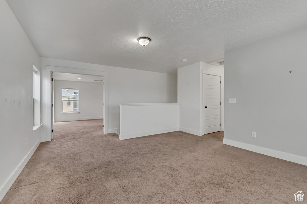 Spare room with carpet floors and a textured ceiling
