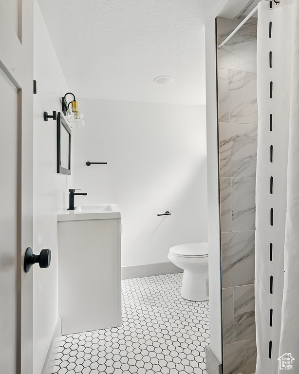 Bathroom with vanity and a marble finish shower