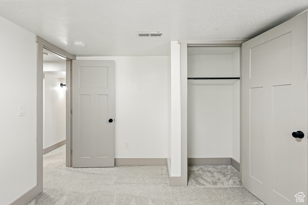 Unfurnished bedroom with carpet flooring and a closet