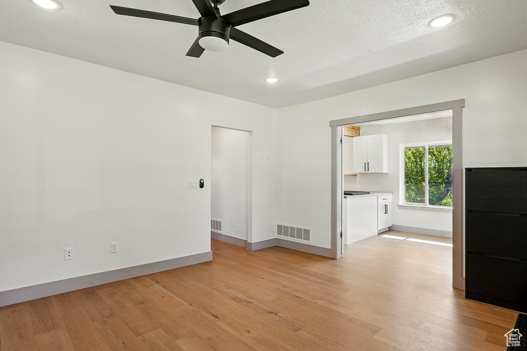 Unfurnished room with light wood-type flooring, a ceiling fan, and recessed lighting