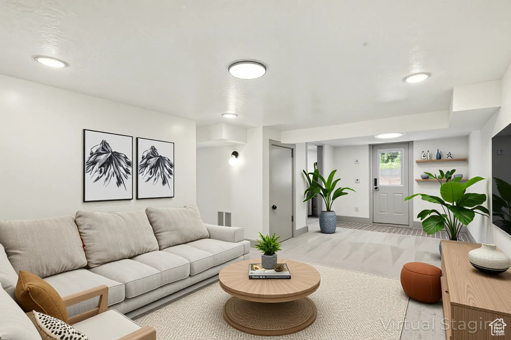 Carpeted living room featuring baseboards and recessed lighting