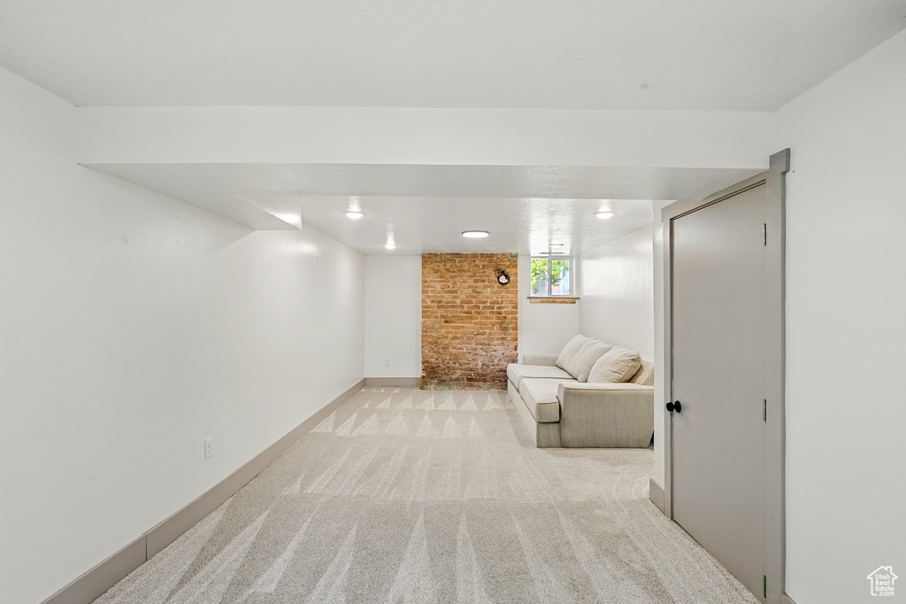 Basement with light colored carpet