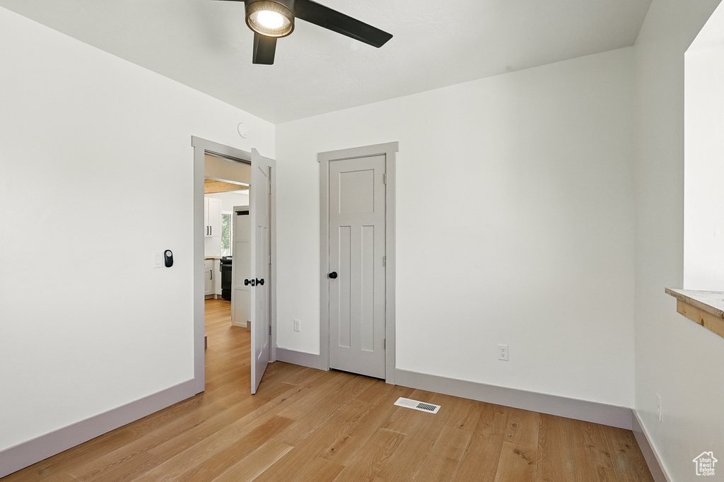 Spare room with ceiling fan and light wood-style flooring