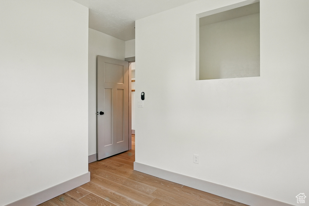 Spare room with light wood finished floors and baseboards