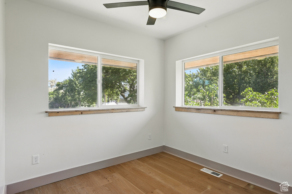 Unfurnished room with a ceiling fan and wood finished floors