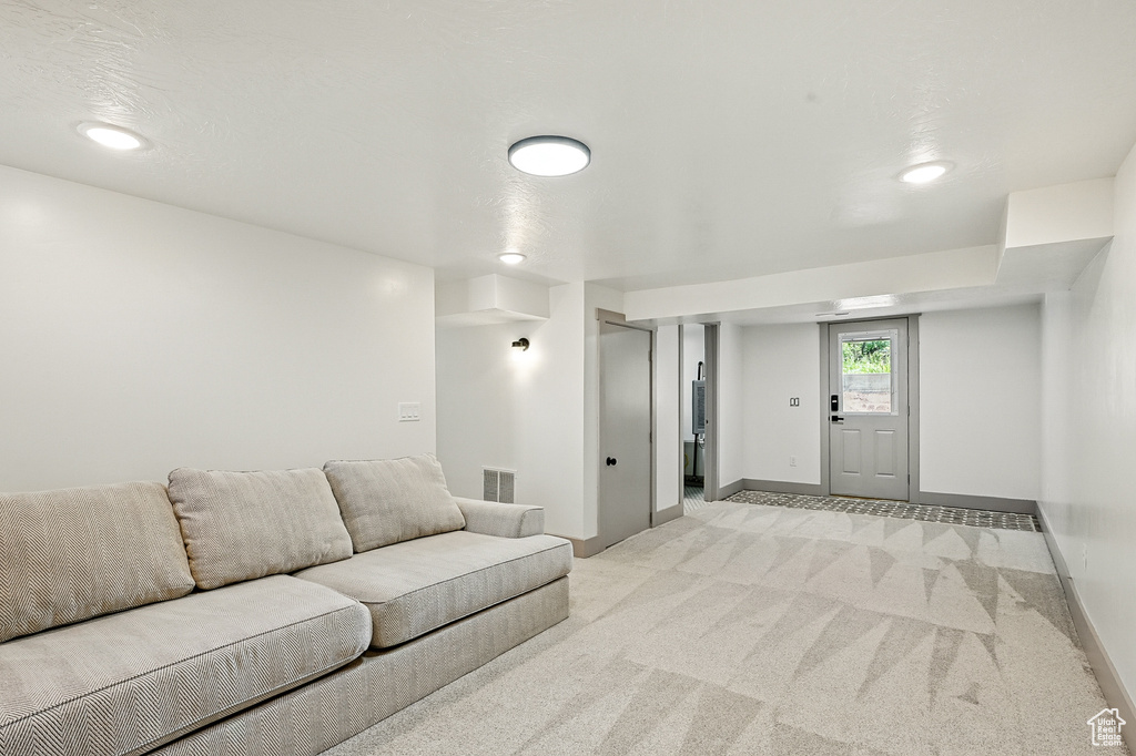 Living room with light colored carpet and recessed lighting