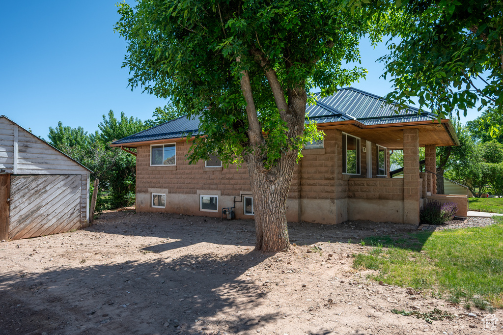 View of side of property with a metal roof