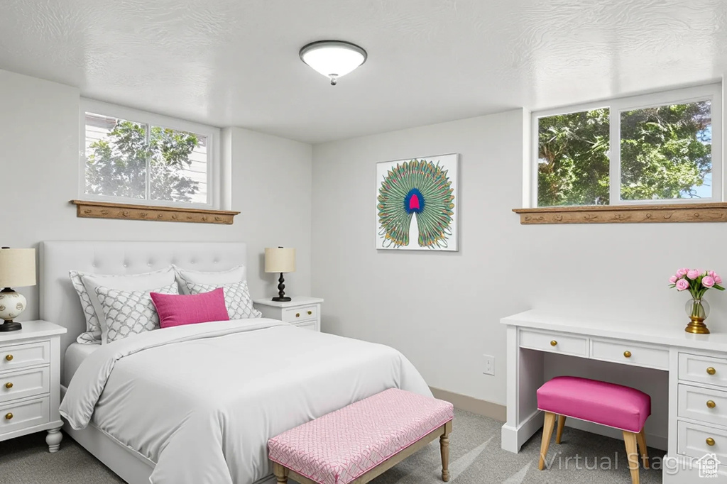 Bedroom featuring light carpet and baseboards