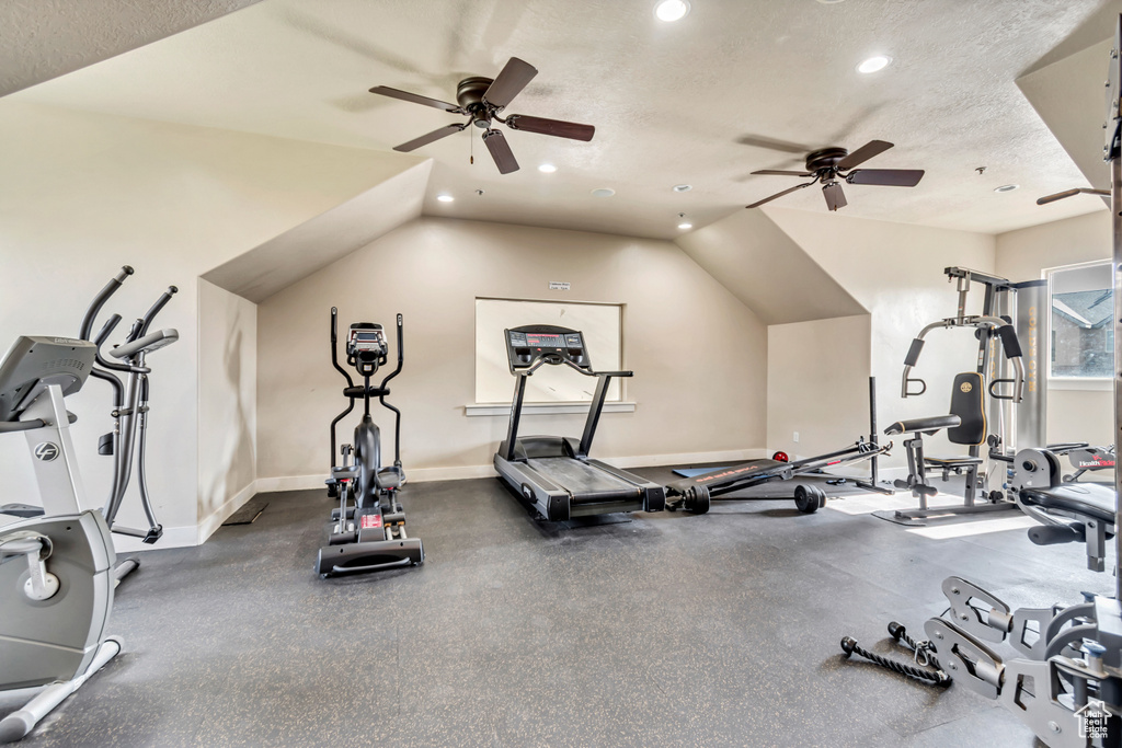 Exercise room featuring a ceiling fan, recessed lighting, lofted ceiling, and a textured ceiling