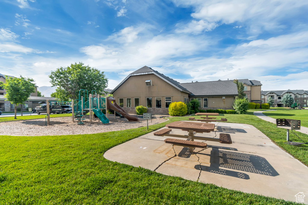 Rear view of property with a lawn