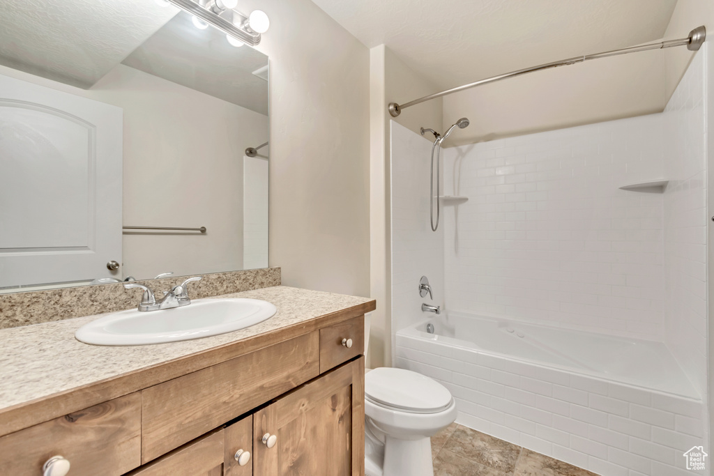 Bathroom with shower / tub combination, vanity, and tile patterned flooring