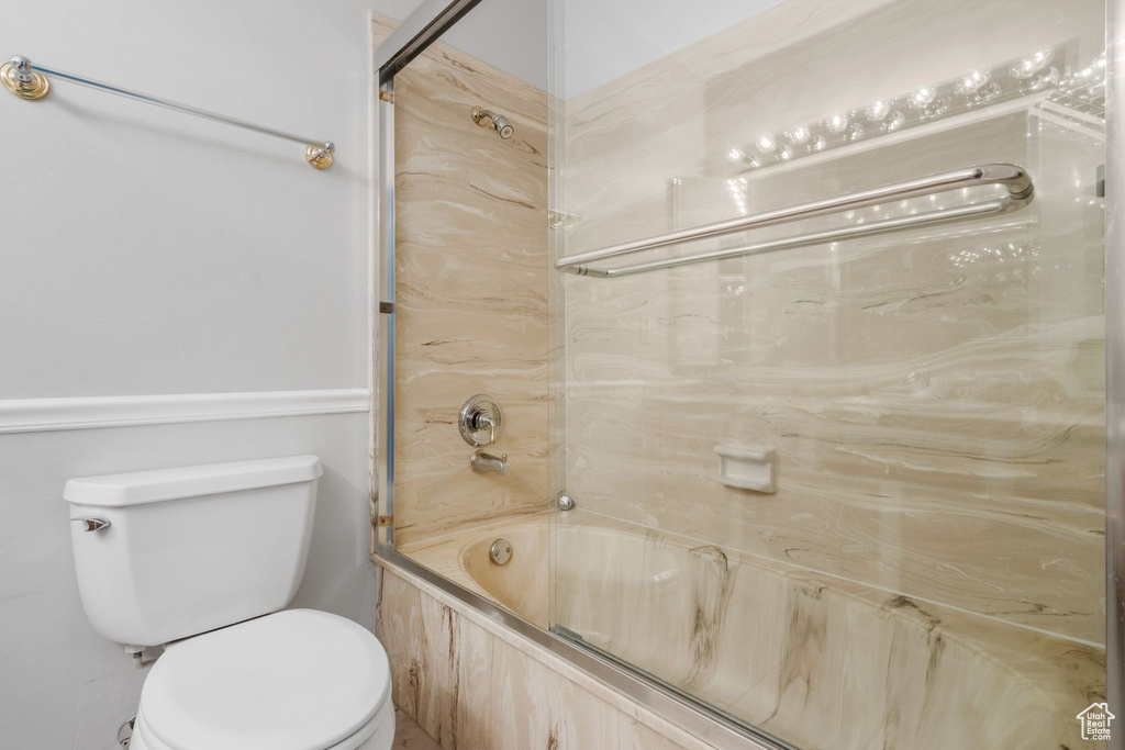 Full bathroom featuring toilet and bathing tub / shower combination