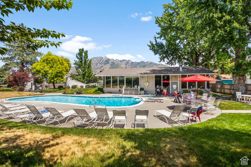 Community pool featuring a mountain view and a patio