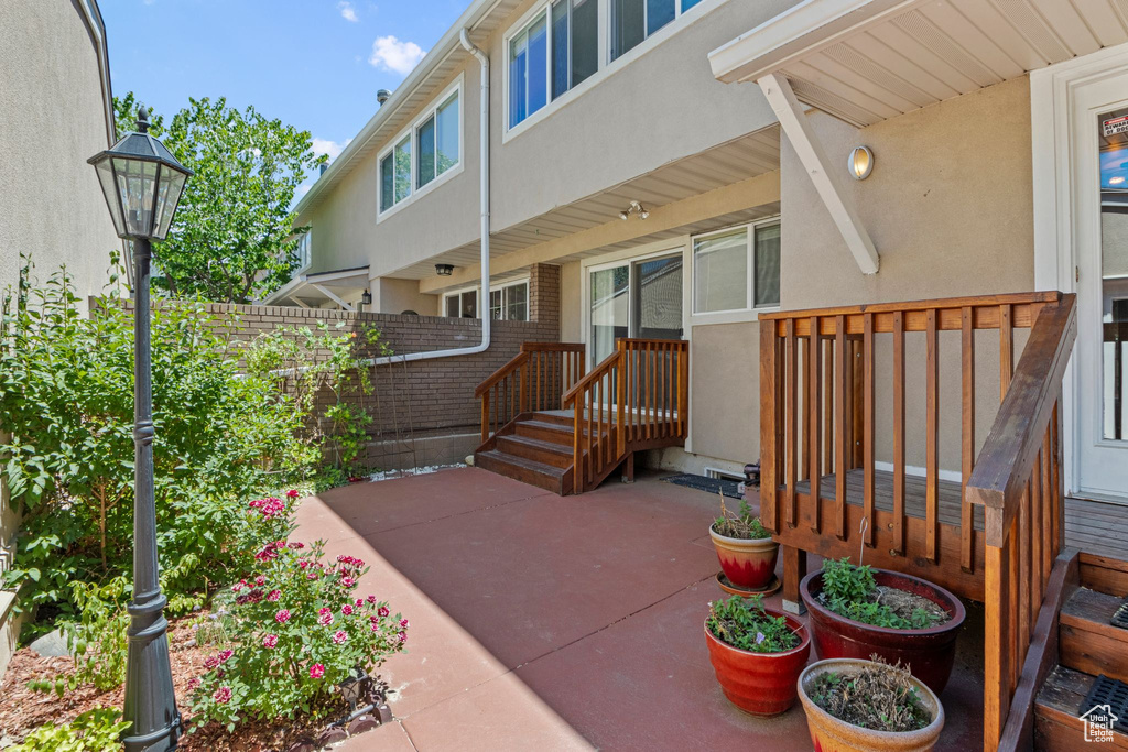 Property entrance featuring stucco siding and a patio area