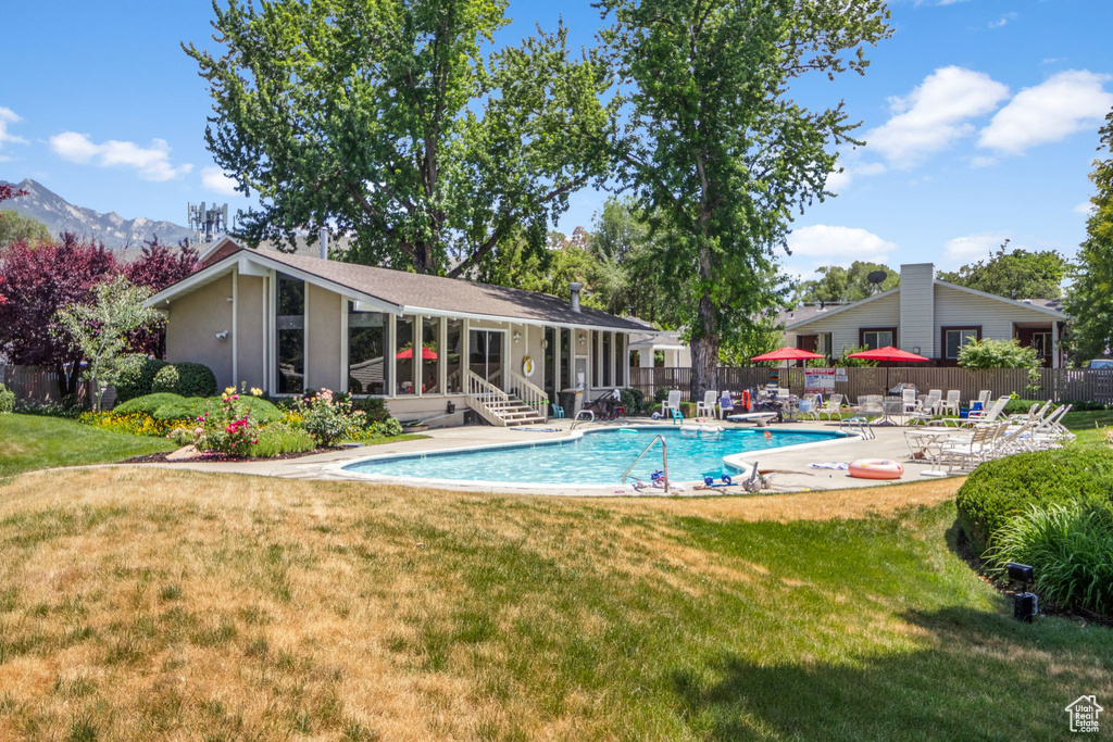 Community pool with a patio area and a mountain view