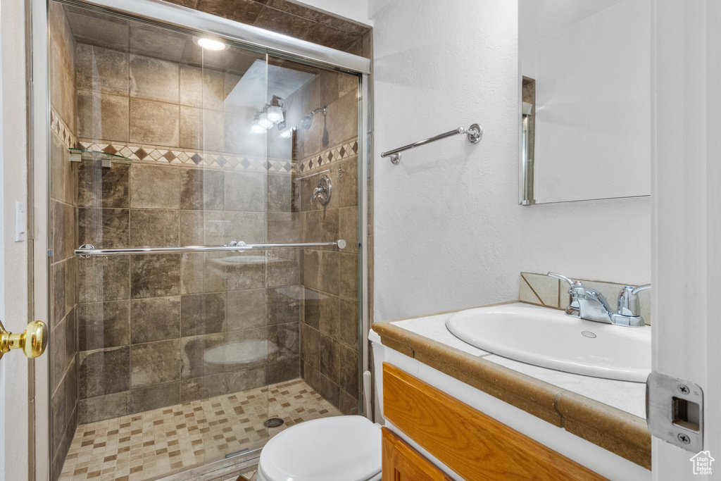 Bathroom with vanity and a shower stall