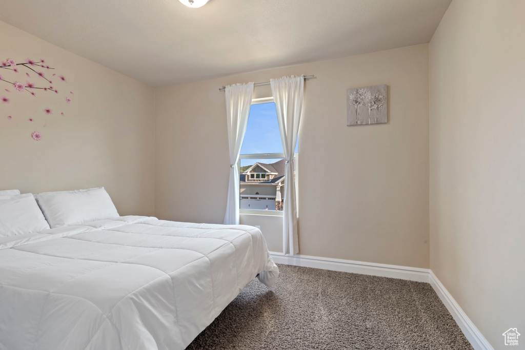 Carpeted bedroom with baseboards