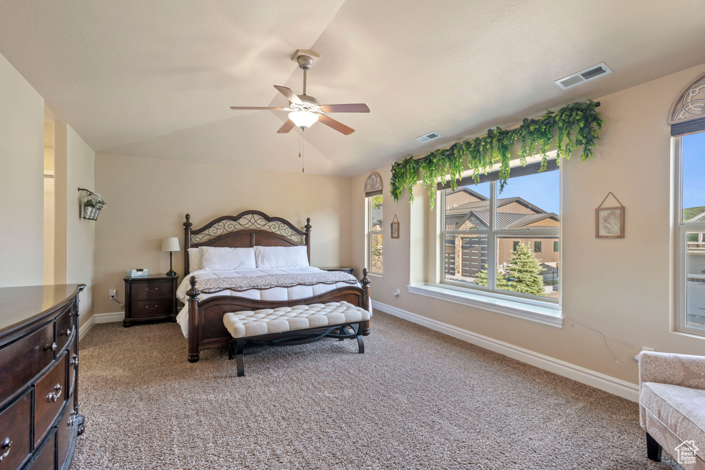 Bedroom with light carpet, lofted ceiling, baseboards, and a ceiling fan