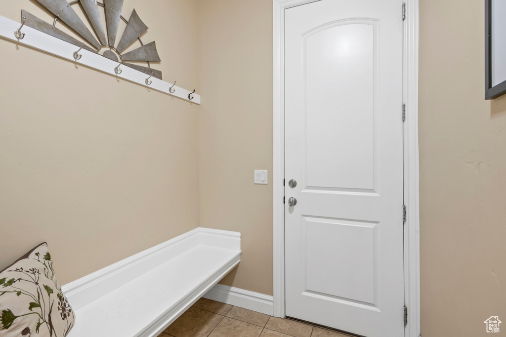 Mudroom with light tile patterned flooring and baseboards