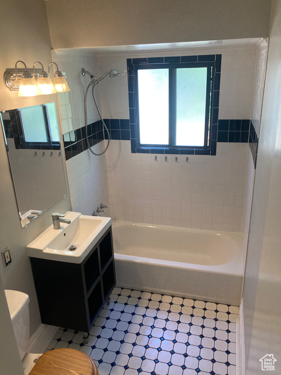 Bathroom featuring  shower combination and vanity