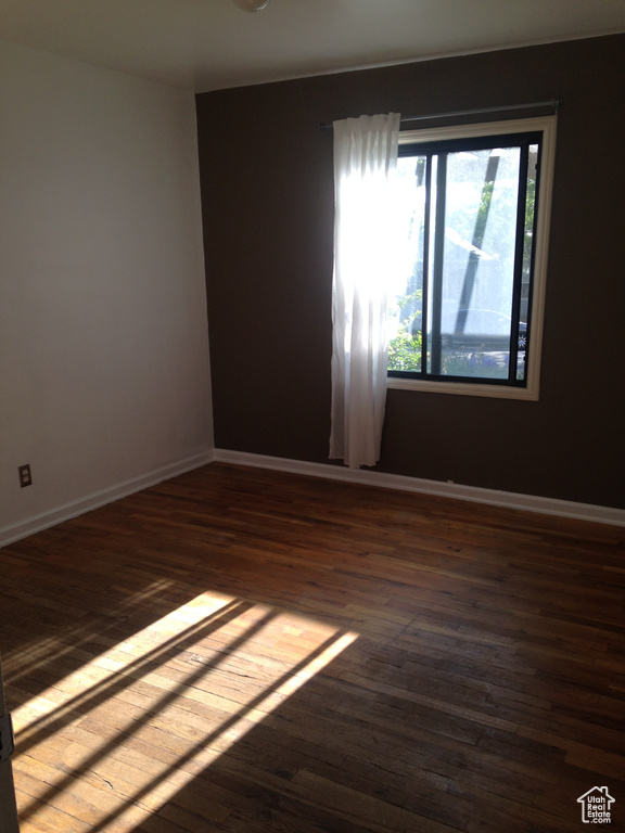 Empty room featuring wood finished floors