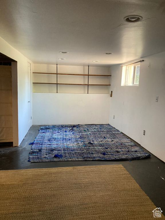 Spare room with unfinished concrete flooring