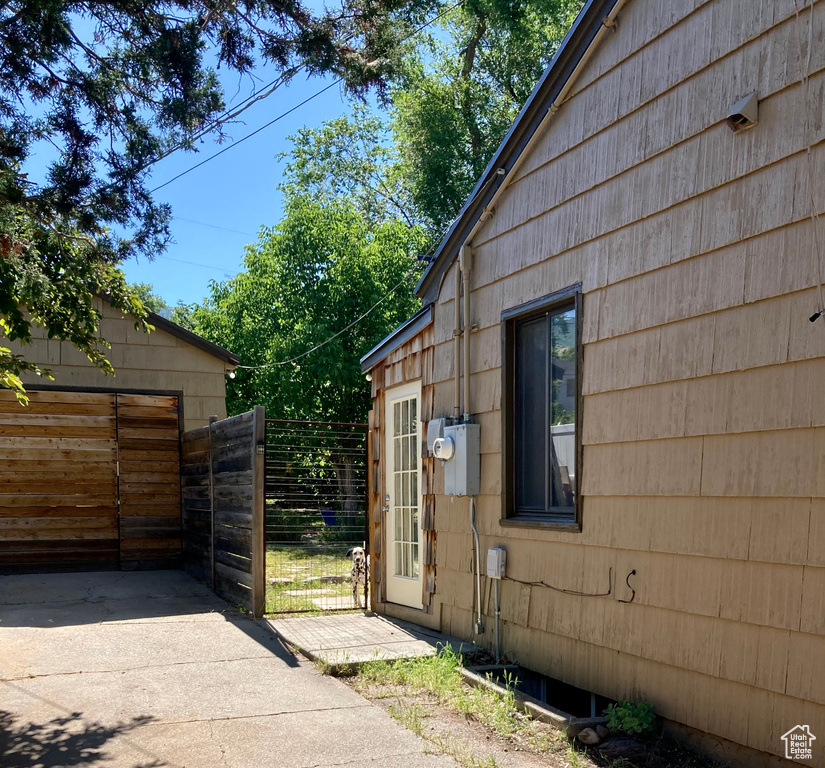 View of property exterior with a gate and a garage