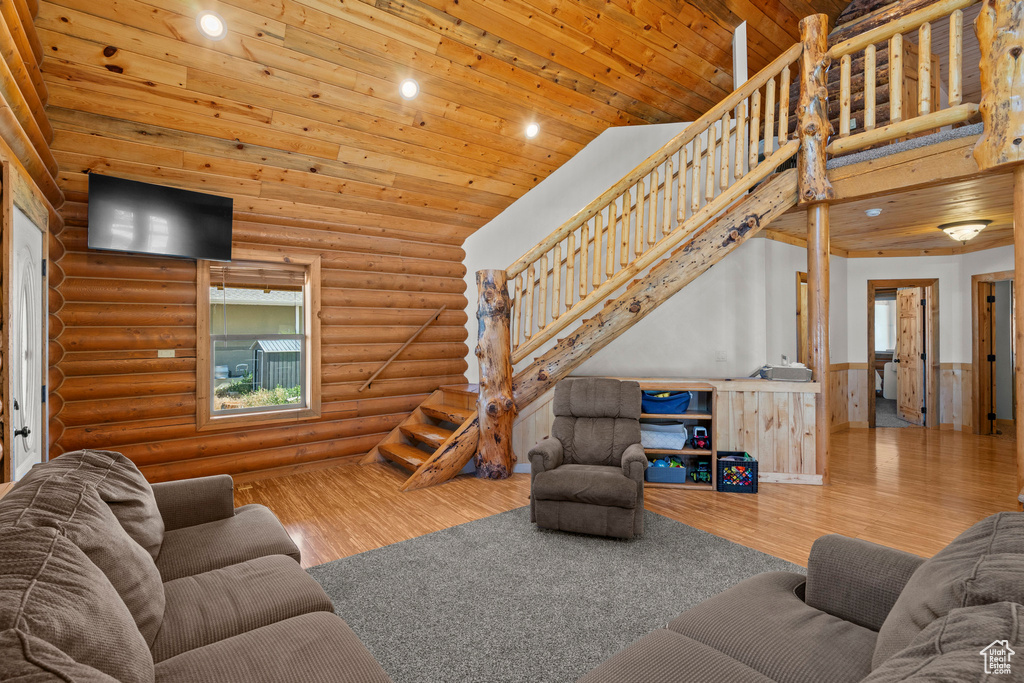 Living room with a wainscoted wall, wood finished floors, stairway, recessed lighting, and wood ceiling