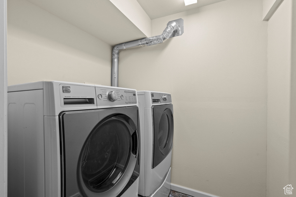 Laundry area with washing machine and dryer and baseboards