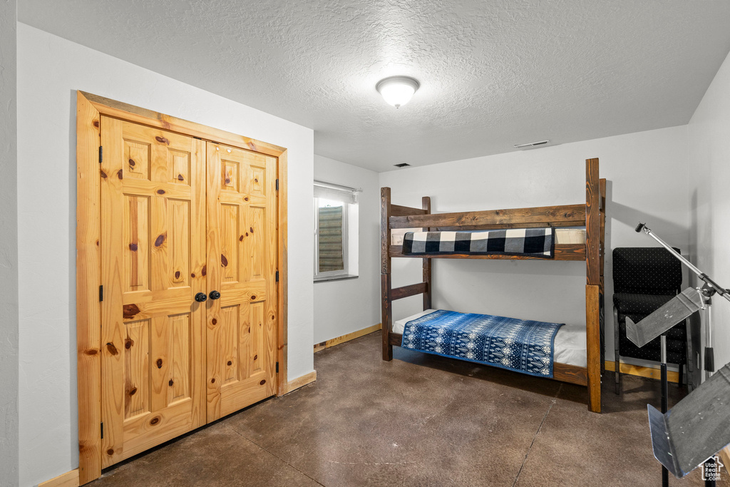 Bedroom with a textured ceiling