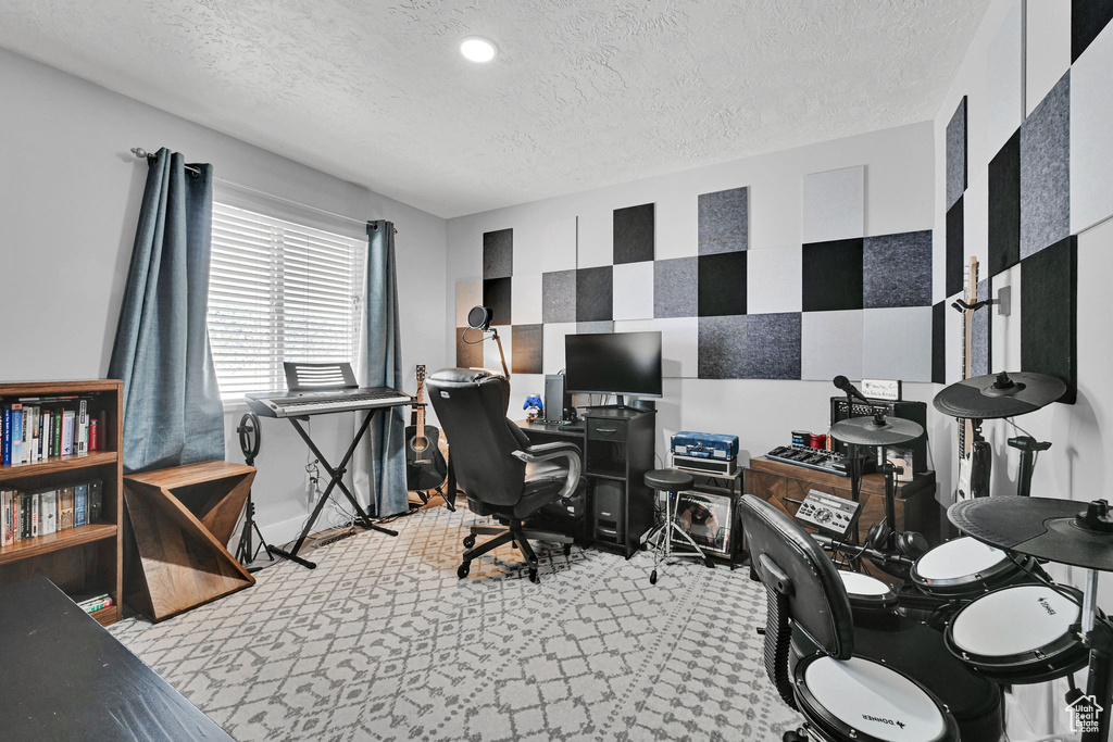 Office area featuring a textured ceiling and recessed lighting